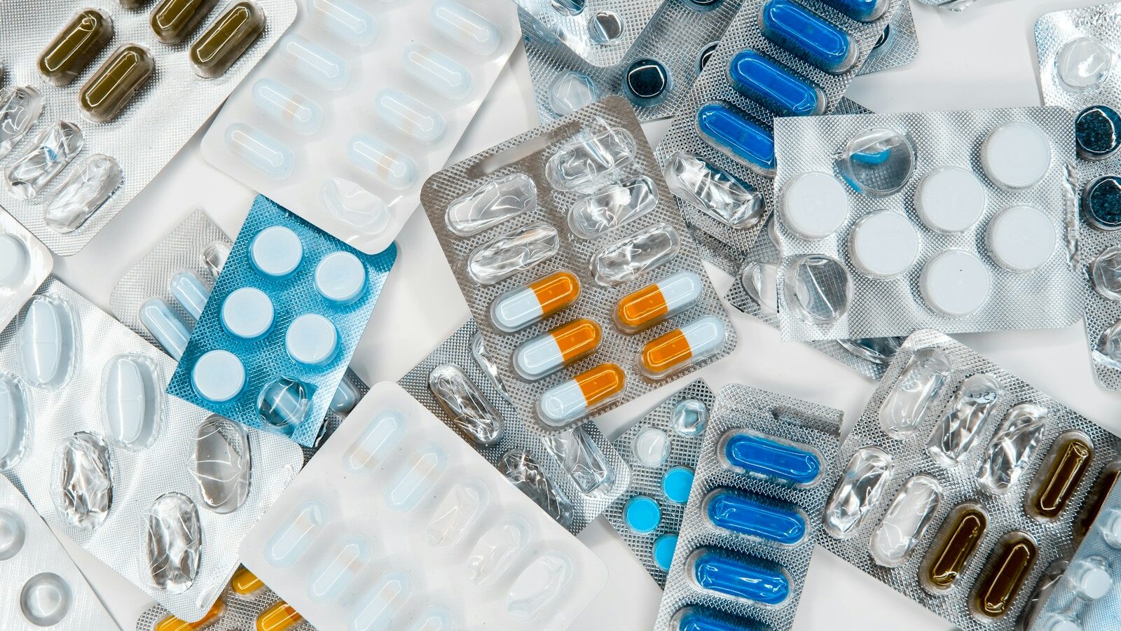 a pile of pills sitting next to each other on top of a table